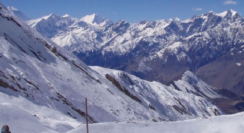 View of Himalayan Peaks on descent from Tharong La high pass on Annapurna circuit trek in the Nepal Himalaya