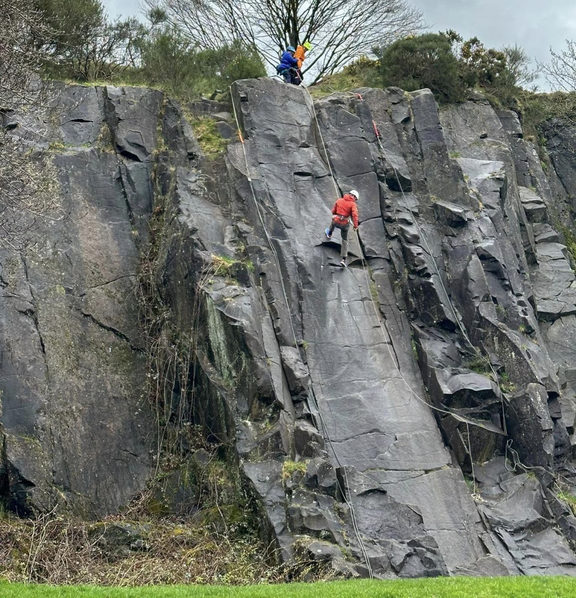 Climbers on quarry rock face in Auchinstarry Park.